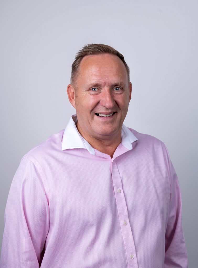Martin Peacock, Group Managing Director wearing a pink shirt