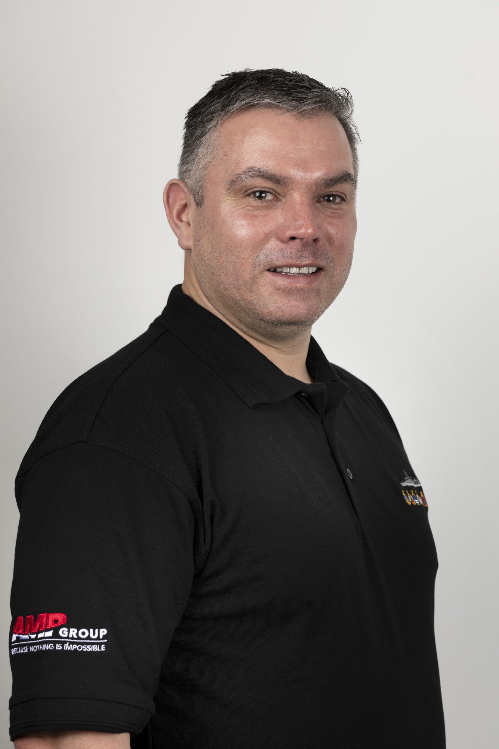 Warehouse & Procurement Technician - Andy Newman, a man in a black polo shirt